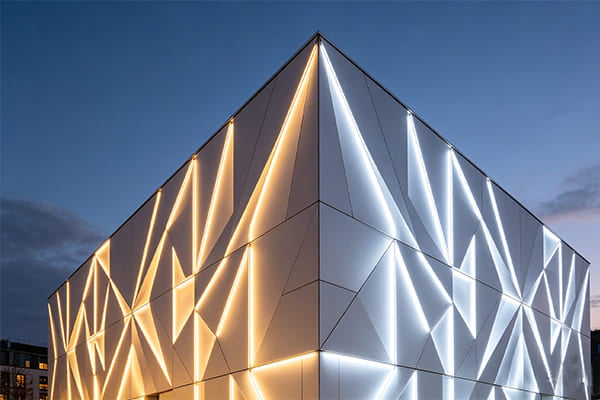 A building facade lit with a mix of warm and cool white light